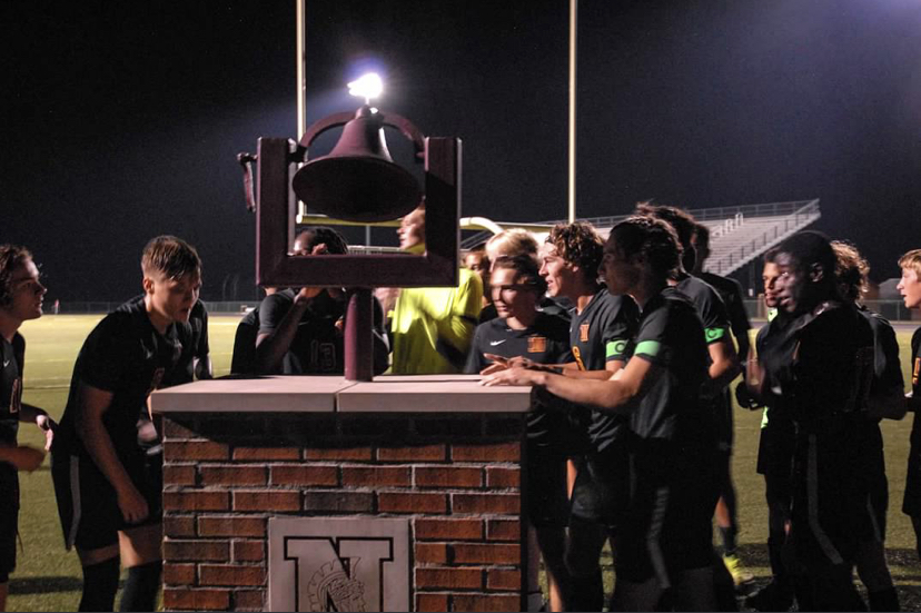 North High Schools boys soccer team ringing the school victory bell. The team went on to have a memorable season.