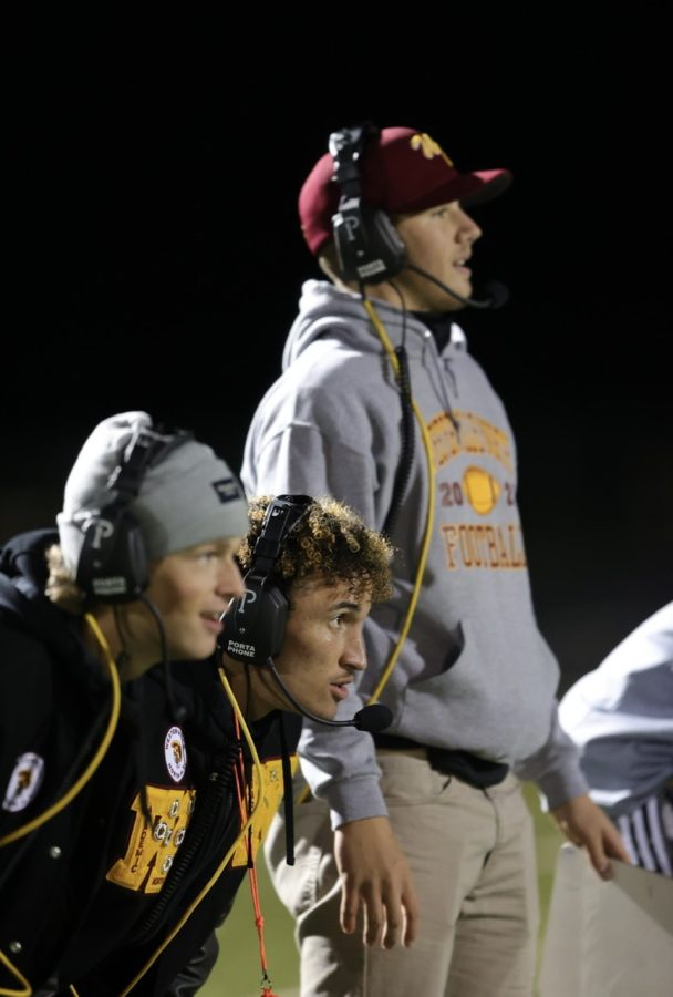 Powderpuff coaches Taz Taylor (12), Donovan Varney (12), and James McCreery (12) watch the game anxiously.