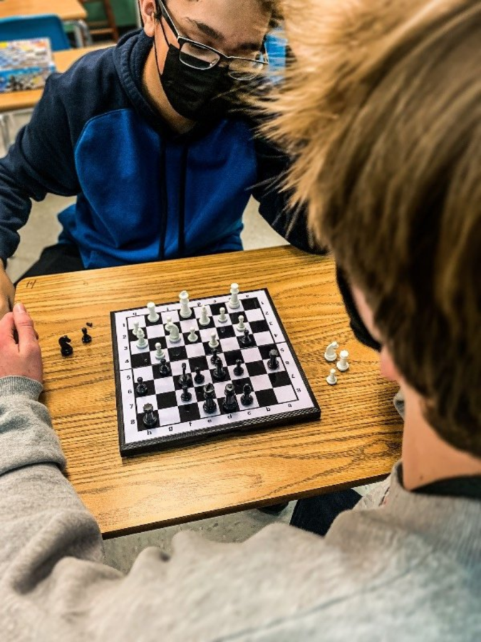 Nick+Rentschler+%289%29+and+Jared+Corbett+%2811%29+play+an+intense+game+of+chess.+Corbett+playing+as+black+won+the+match+against+Rentschler.