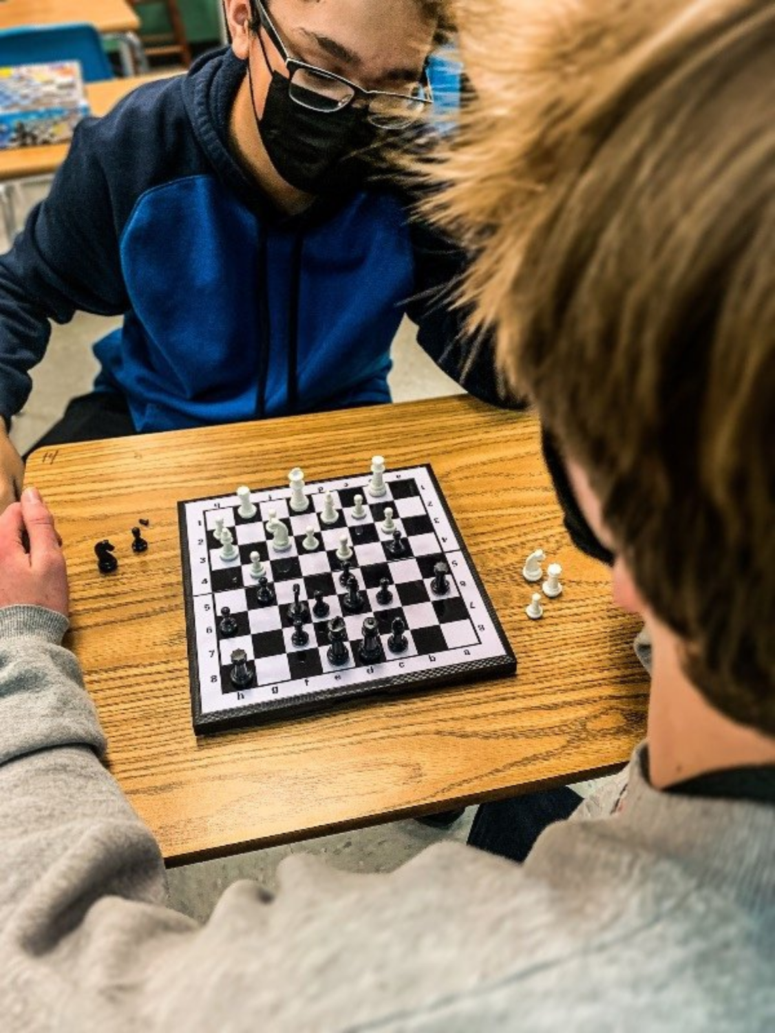 Nick Rentschler (9) and Jared Corbett (11) play an intense game of chess. Corbett playing as black won the match against Rentschler.