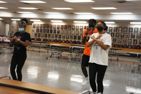 (From left to right) Hadja Sakho (11), Jonathan Henry (12) Kaia Calhoun (12) practice their dance routine for Black History Months performance. Timeless will be performed February 17 at 7 p.m. in the auditorium.