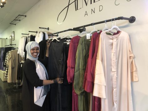 Maryan Farah arranges dresses while checking out the items in stock. Farah always double checks to make sure things are in their right place.