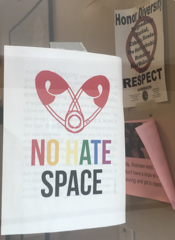 A No Hate Space poster hangs on a window in a classroom. Teachers will hang signs to showcase alllyship.