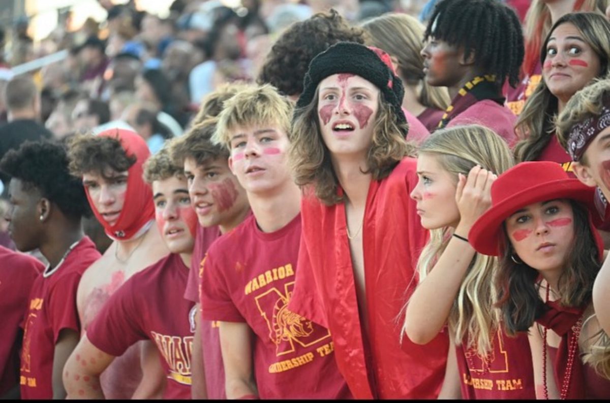WNHS+students+stand+together+in+their+cardinal+crazy+outfits.+They+cheer+the+football+team+onto+victory.