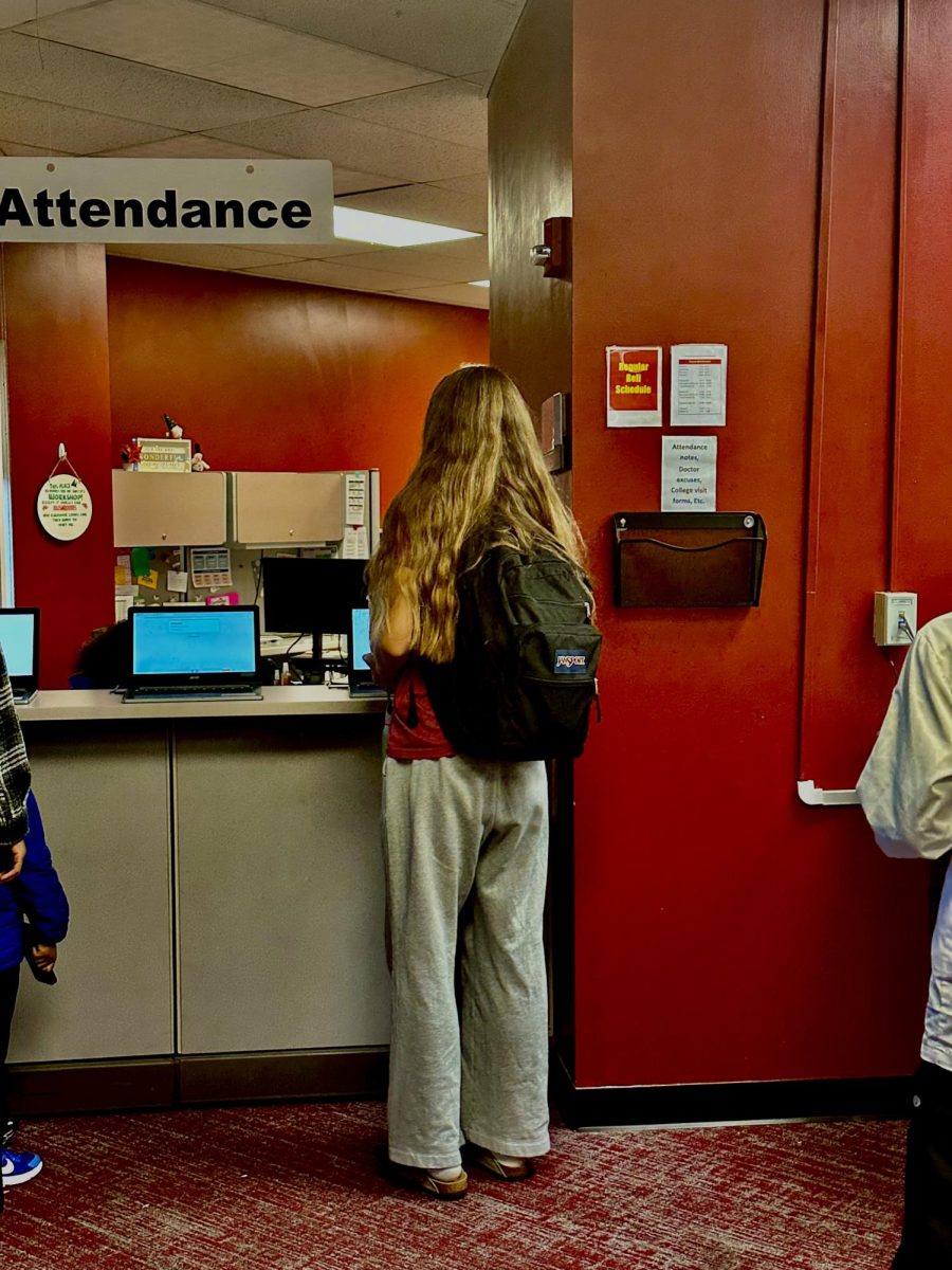 alexis hamm (2027) signing into school at the attendance office for coming in late. 