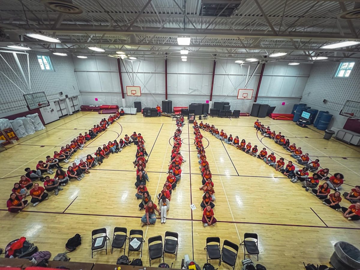 Students practice a tradition of the Warrior Way Leadership Summit by orienting themselves into a large 'W' and 'N' for a picture.