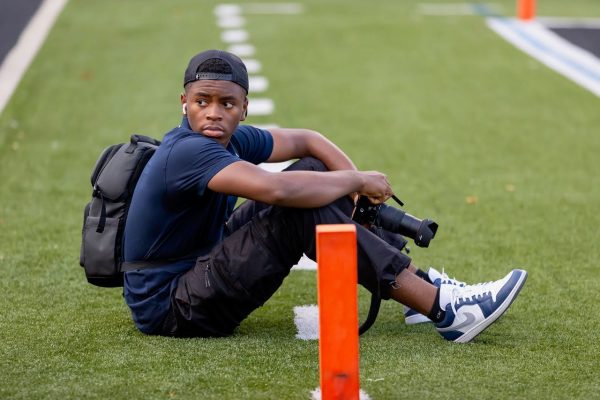 Ashu ('26) sitting on the field at Westerville Central during the North Central football game.