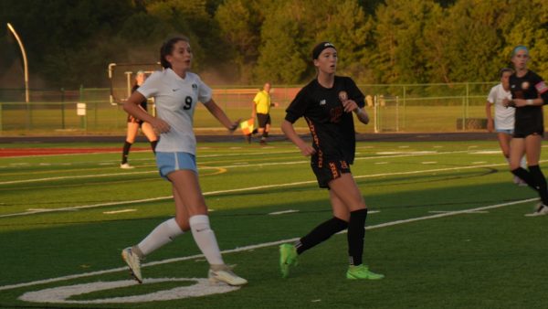 Jade Mckelvey (2029), in black uniform, runs upfield looking for the ball 