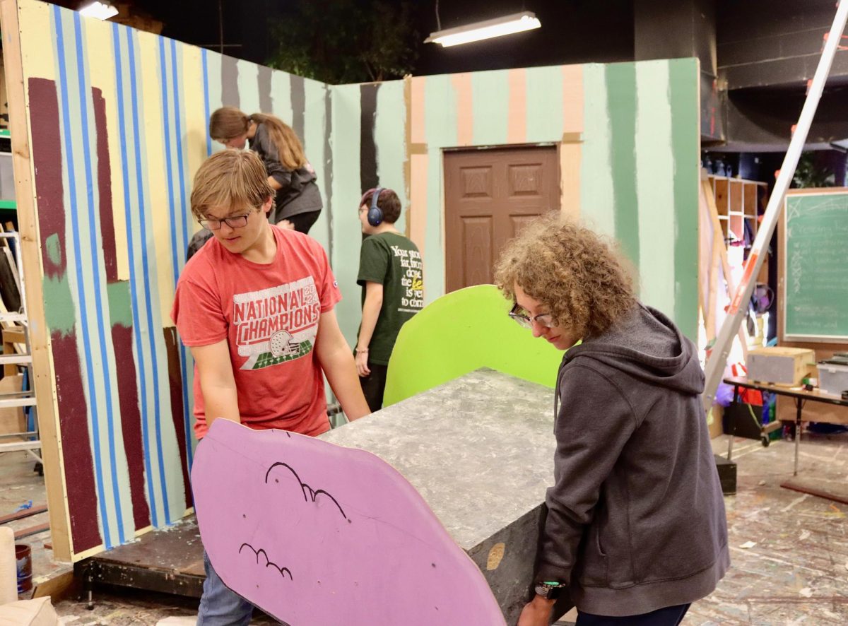 Moving set: Ryan Tipple ('26) and Miles Keyser ('26) carefully move a set piece after it was completed. 
