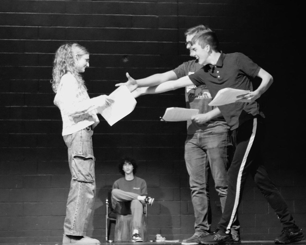 Black and White: Tweedle Dee and Tweedle Dum actors Ryan Tipple and Matt Fouse ('27) in a scene with Alice (Caney) where they are eager to meet her.