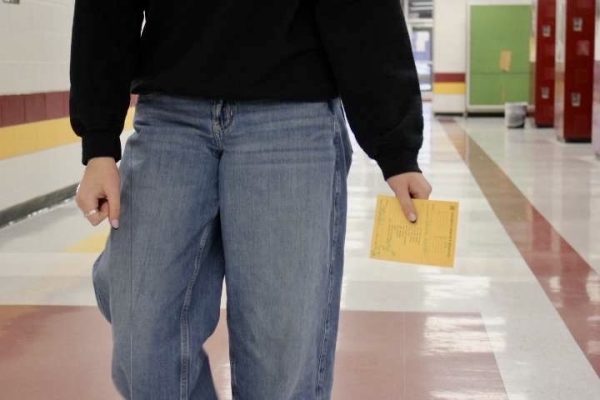 A student walking in the halls with a late slip in the middle of the day